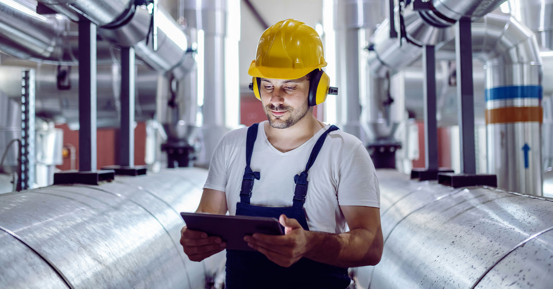 Engineer in an oil oil refinery with tablet