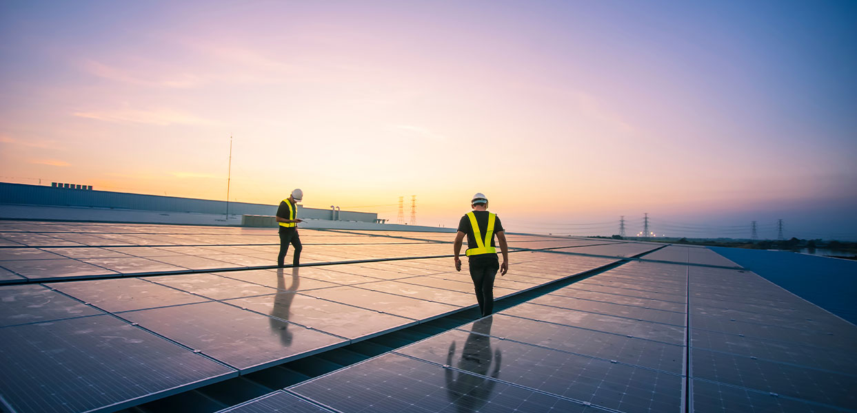 Engineer service check installation solar cell on the roof of factory on the morning.