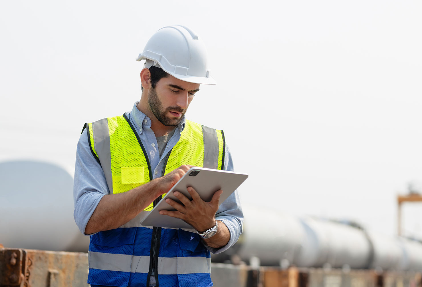 Heavy-duty industrial engineers stand in a pipeline manufacturing facility