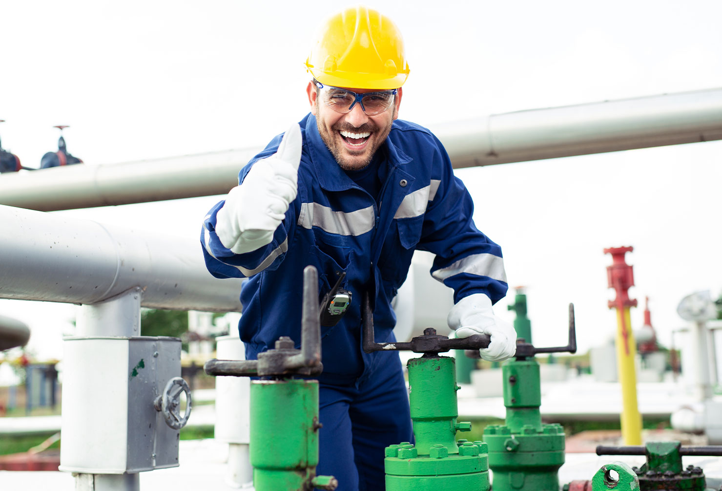 Worker closes the valve on the oil pipeline