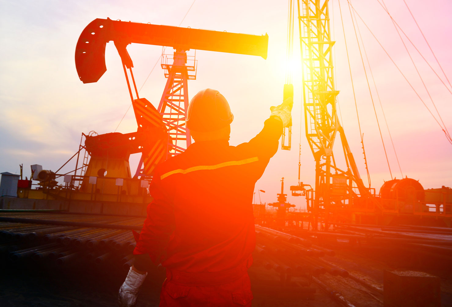 oil and gas engineer in front of oil refinery equipment