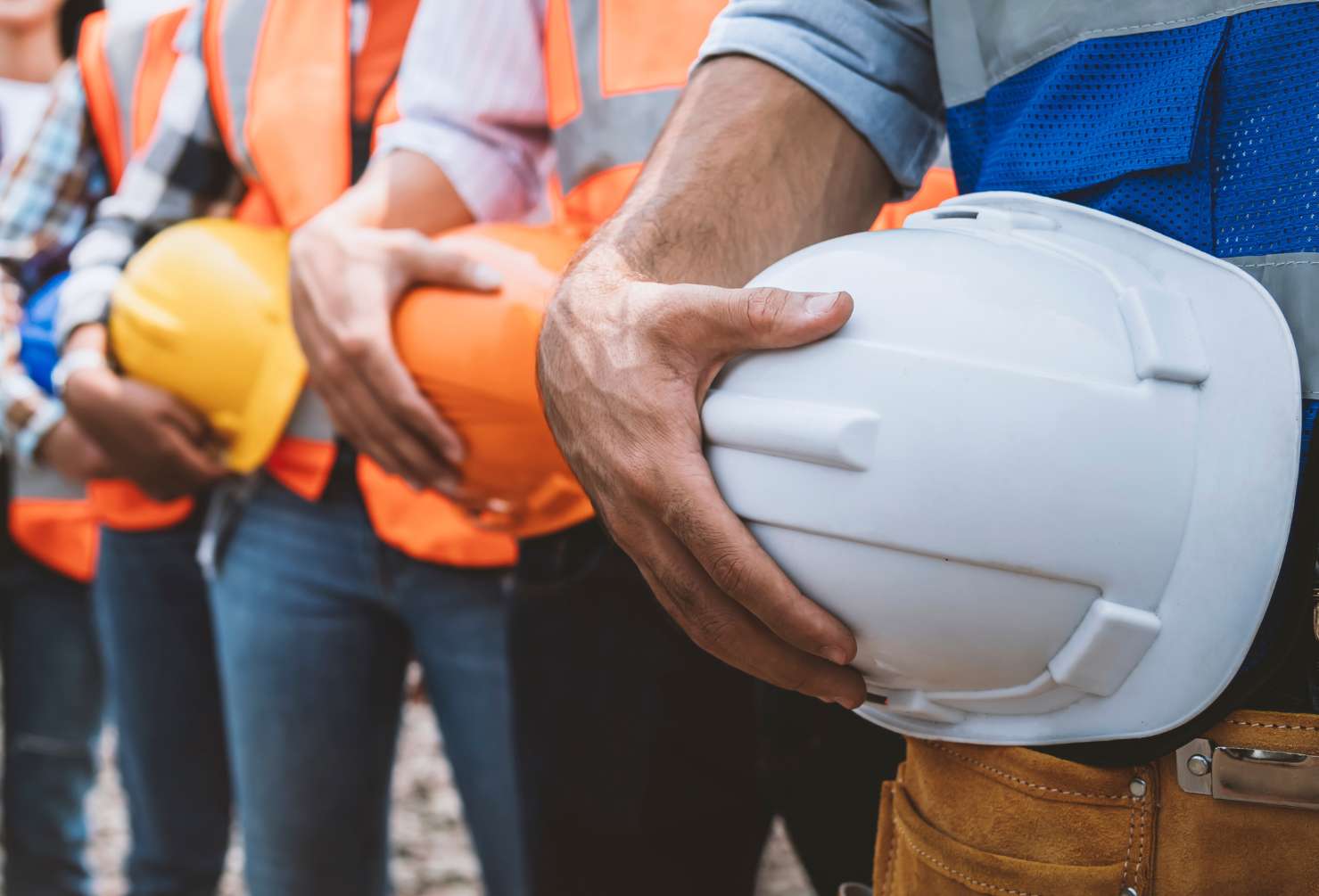 5 In-Demand Trades Making a Comeback in Australian Oil & Gas Team of engineers and tradesmen holding helmets standing in row on site work
