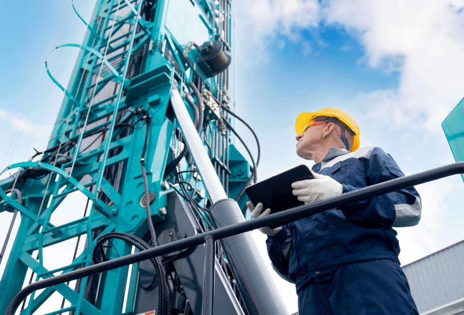 Industry operator use computer tablet for control rig platform for drilling wells for installing explosives on open pit mine coal, mineral, marble.