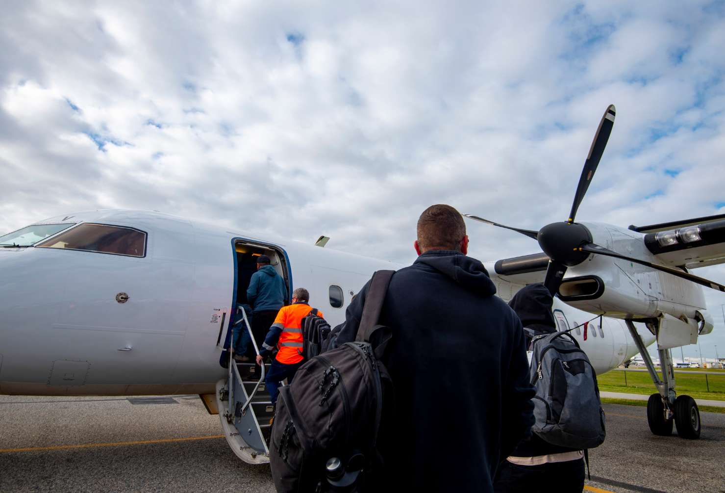 Enxgy-Blog-FIFO-Skills-For-Success-Remote-Gas-Projects Roster Workers in the Natural Resources Sector, FIFO workers in the oil and gas industry walking towards a plane