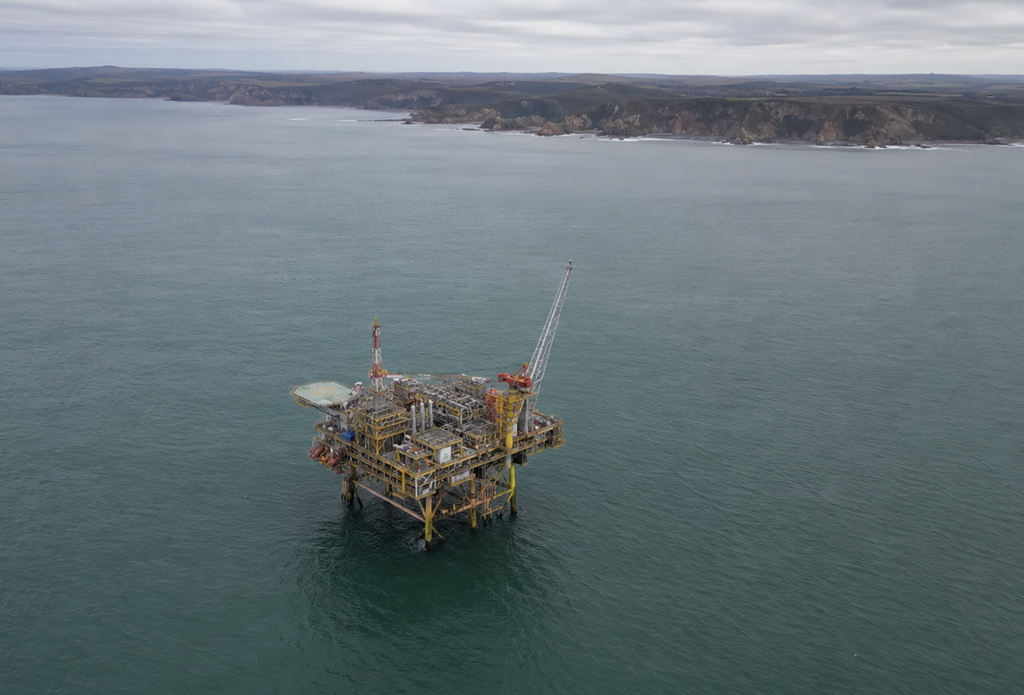 Aerial view of a small offshore gas production platform in calm grey-green waters off the Victorian coastline Australia,