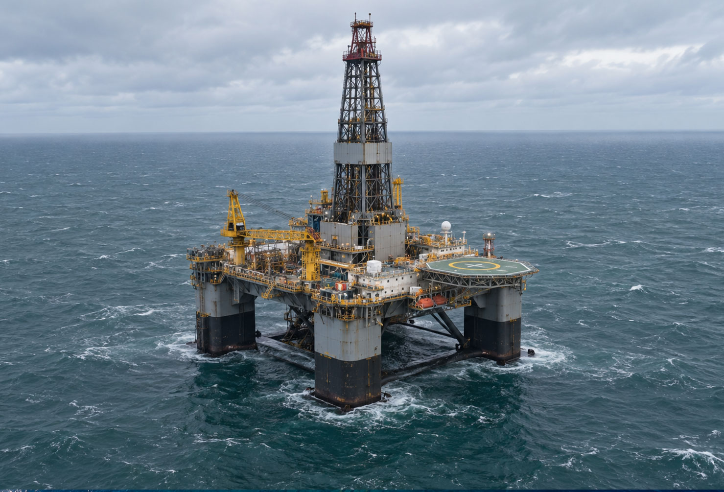 Aerial view of a semi-submersible offshore drilling rig in grey-green waters off the Victorian coast, overcast southern ocean conditions