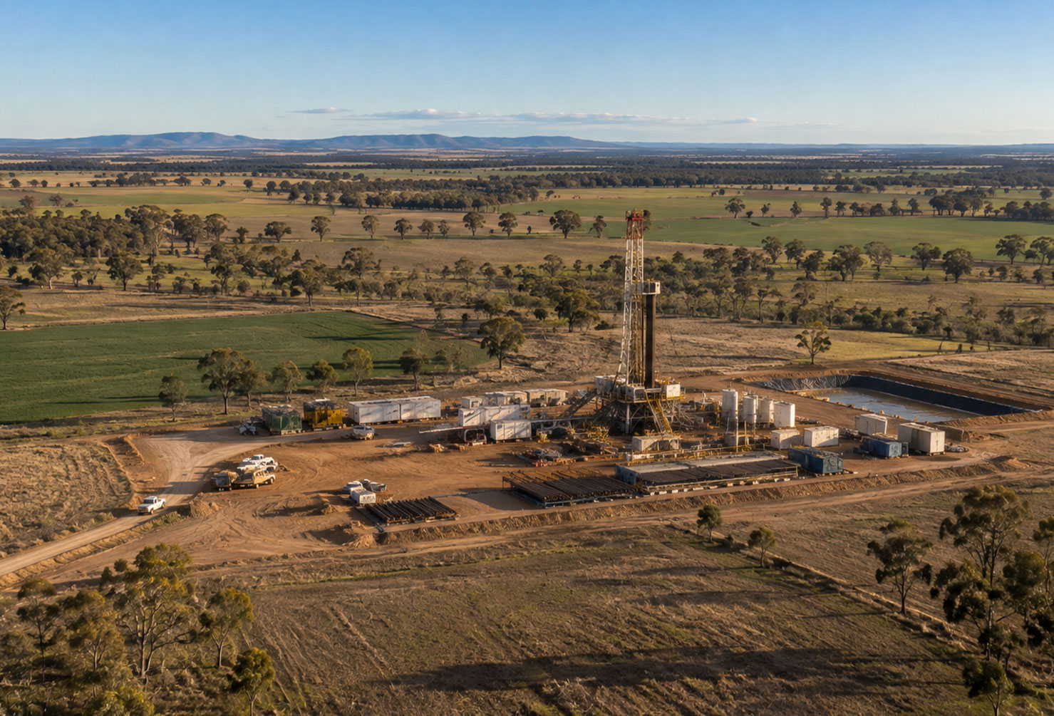 Aerial view of an onshore drilling rig and wellsite surrounded by farmland in Queensland's Western Downs